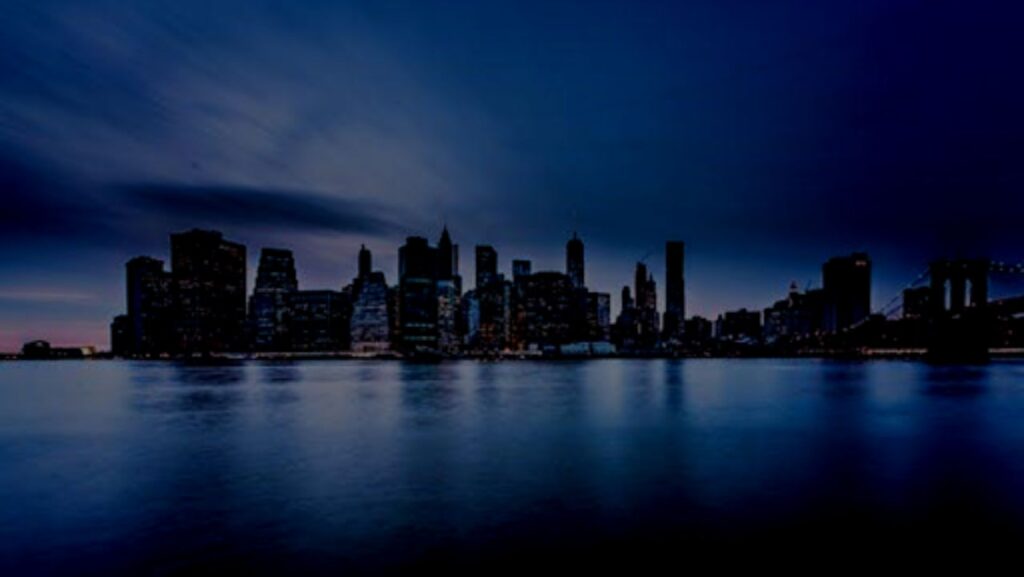 A panoramic view of the New York City skyline with the Brooklyn Bridge in the foreground, showcasing various New York City neighborhoods