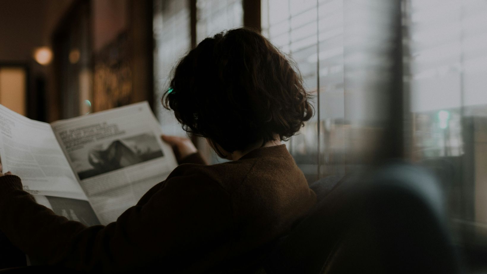 Person looking at a magazine