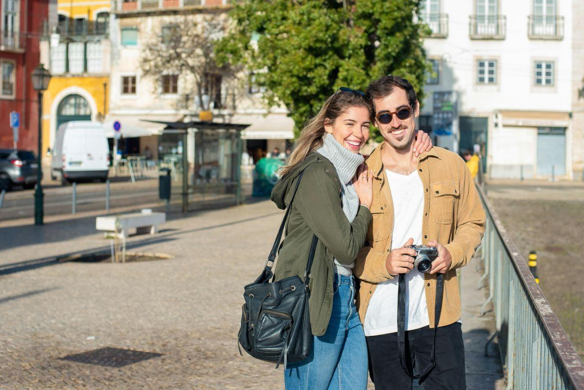 Smiling couple exploring a walkable city street, showing what makes smaller Midwestern cities easy to settle into through comfort, ease, and everyday appeal.